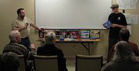 (Image: A wide shot of both Robert Downs and Richard during thier presentation.)